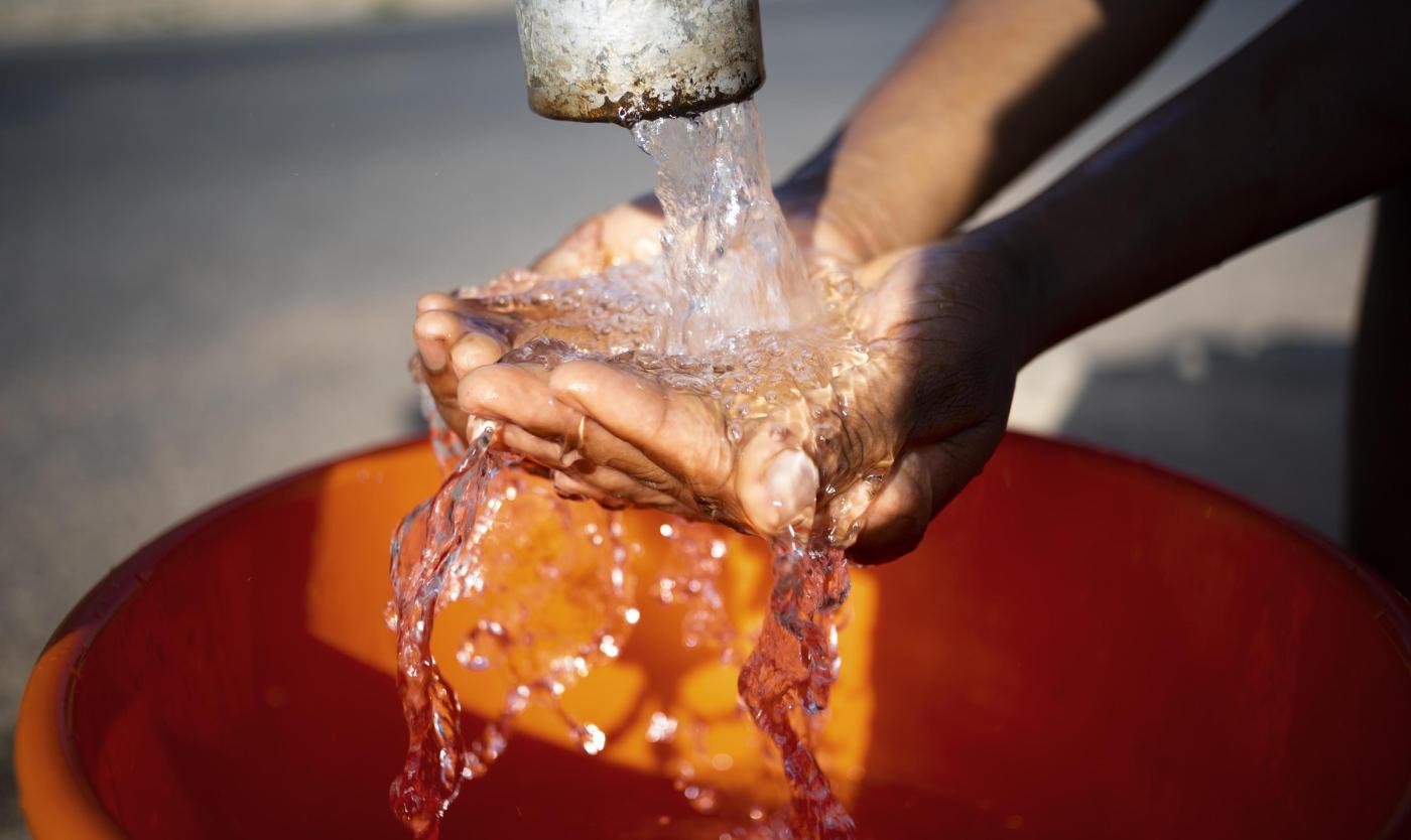 African woman pouring water