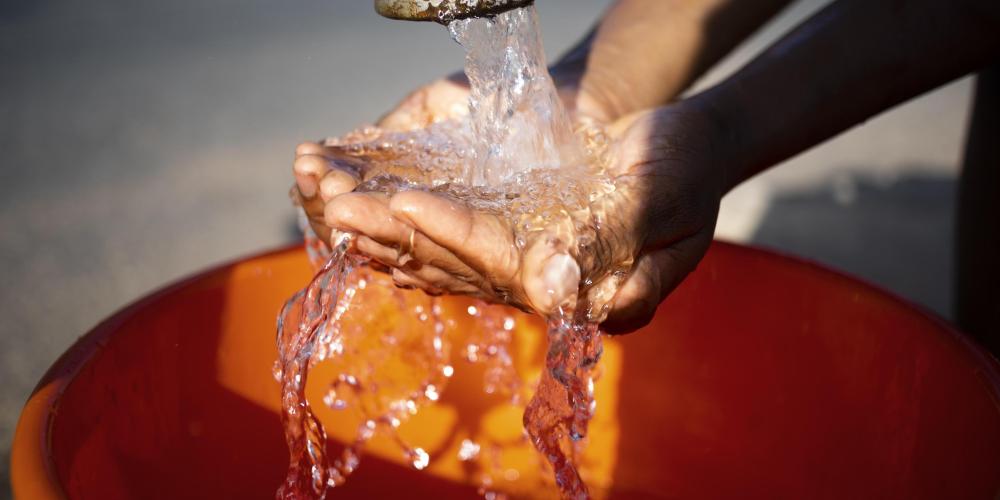 African woman pouring water